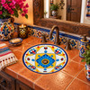 Round talavera bathroom sink blue flower design Mexico in a colorful Mexican style bathroom