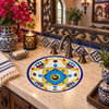 Round talavera bathroom sink blue flower design Mexico in a Spanish Revival bathroom setting