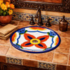 Round talavera bathroom sink terracotta petal motif in a hacienda bathroom with rustic elements