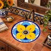 Round talavera bathroom sink with yellow flower design in a warm Mexican style interior