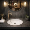 Round white talavera bathroom sink modern ceramic design in restaurant bathroom with refined interior