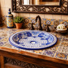Round talavera bathroom sink blue floral Mexican design in Spanish style bathroom with rustic vanity
