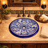 Round talavera bathroom sink blue white floral design in a restaurant bathroom with warm lighting and rustic finishes