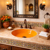 Round Mexican bathroom sink solid orange talavera design in Spanish Revival bathroom with warm tones