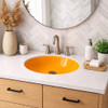 Round Mexican bathroom sink solid orange talavera design in modern bathroom with clean neutral finishes