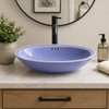Double sided hand painted oval bathroom sink blue in a Spanish Revival bathroom vanity