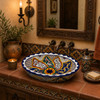 Double sided hand painted oval baroque bathroom sink in hacienda style powder room