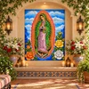 Our lady of Guadalupe tile mural in a floral prayer alcove with candles and roses.