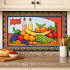 Mexican talavera tile mural fruit harvest installed as kitchen backsplash with warm colors