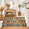 Mexican tile stair risers and landing in American suburban interior, colorful Talavera patterns lining each step with hand painted detail