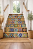 Mexican tile stair risers in transitional house interior, colorful Talavera patterns lining each step with hand painted ceramic detail