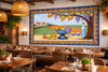 Mexican vineyard talavera tile mural design displayed in a restaurant feature wall creating a warm Spanish inspired setting