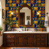 Mexican sun and moon tile mix framing a bathroom vanity with colorful celestial motifs