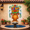 Talavera flower vase tile mural with white doves courtyard wall feature in Spanish Revival house patio setting