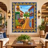 Mexican tile mural with Spanish colonial village in a boutique hotel lobby with artisan furnishings.