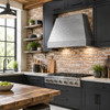 Under-cabinet hammered zinc range hood in a dark industrial kitchen with brick, black cabinets, and reclaimed wood