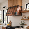 Hand-hammered copper hood with vertical straps, oxidized patina in modern farmhouse kitchen with shiplap