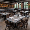 Square zinc tabletops and a zinc bar counter featured in a restaurant interior