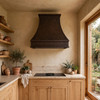 Organic modern kitchen with dark coffee hand hammered copper range hood oak cabinets stone counters side window