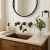 Artisan brass leaf-handle faucet with cculpted organic design in a bathroom
