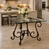 Forged iron table legs - decorative scroll in a luxury kitchen with a refined glass tabletop