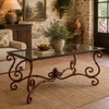 Rectangular forged iron table stand with glass top in a cozy rustic interior with warm wood accents