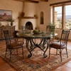 Southwestern forged iron table base with glass top in a Southwestern home with rustic decor