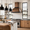 Warm industrial kitchen with dome bell copper hood, forged iron straps and pyramid rivets over white oak island