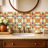 Talavera relief tile quatrefoil cross floral pattern installed as a bathroom vanity backsplash with strong natural light