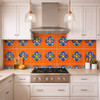 Talavera relief tile floral medallion design installed on a kitchen wall highlighting bold color and deep ceramic relief