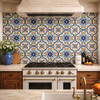 Mexican relief tile blue floral medallion design installed as kitchen backsplash with sculpted blue floral pattern