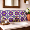 Talavera relief tile purple floral star design installed on bathroom vanity backsplash highlighting deep relief detail