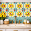 Talavera relief tile yellow floral scroll pattern used on bathroom wall highlighting sculpted relief and solid colors