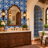 Talavera relief tile with blue floral design in an elegant Spanish Revival bathroom
