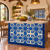 Talavera relief tile with blue floral design installed on a Mediterranean kitchen island