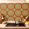 Talavera relief tile quatrefoil floral medallion installed as kitchen backsplash, bold raised ceramic detail creating depth