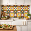Talavera relief tile floral medallion square installed on a kitchen wall highlighting solid colors and deep relief