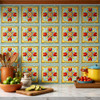 Mexican floral medallion talavera relief tile design installed as a kitchen backsplash with strong natural light and solid embossed colors