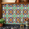 Handcrafted talavera acanthus floral relief tile installed as kitchen backsplash with natural light