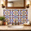 Talavera circular fleur cross relief tile installed on a bathroom vanity wall highlighting sculptural relief
