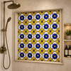 Talavera relief tile cobalt geometric flower pattern used as a shower accent with bold color contrast
