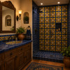 Mexican relief tile yellow rustic motif on a bathroom wall with colorful raised artisan relief