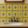 Mexican relief tile golden cross arabesque featured on a bathroom vanity backsplash with artisan style