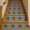 Talavera relief tile with red green floral scroll 6"x6" decorating wooden stair risers in a rustic interior staircase