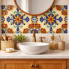 Talavera relief medallion tile enhancing a bathroom vanity wall with raised detail and artisan character