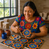 Mexican relief tile black orange star being pa hand-painted by the Mexican artisan in Dolores Hidalgo workshop studio