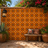 Mexican relief tile floral star design installed on outdoor wall with visible tile pattern and texture