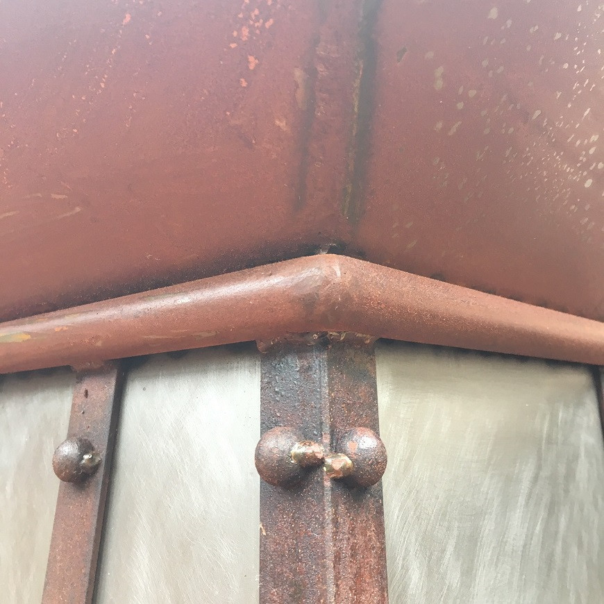 Loft style iron range hood with curved panels crown modling view