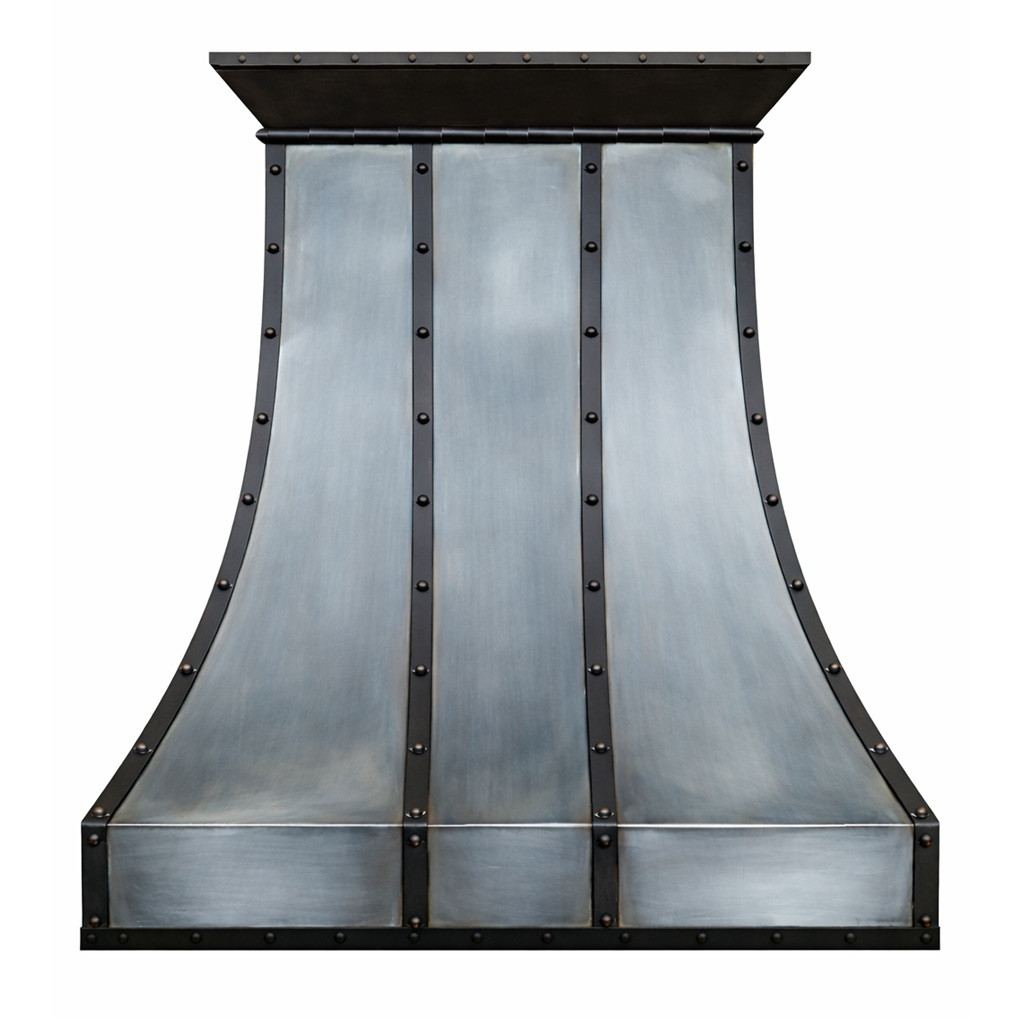 Loft style iron range hood with curved panels featuring a tall sculpted bell profile