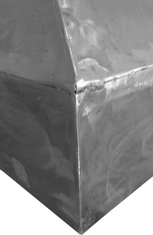 Handmade raw natural iron range hood with tapered bell silhouette detail showing seem on the hood edge